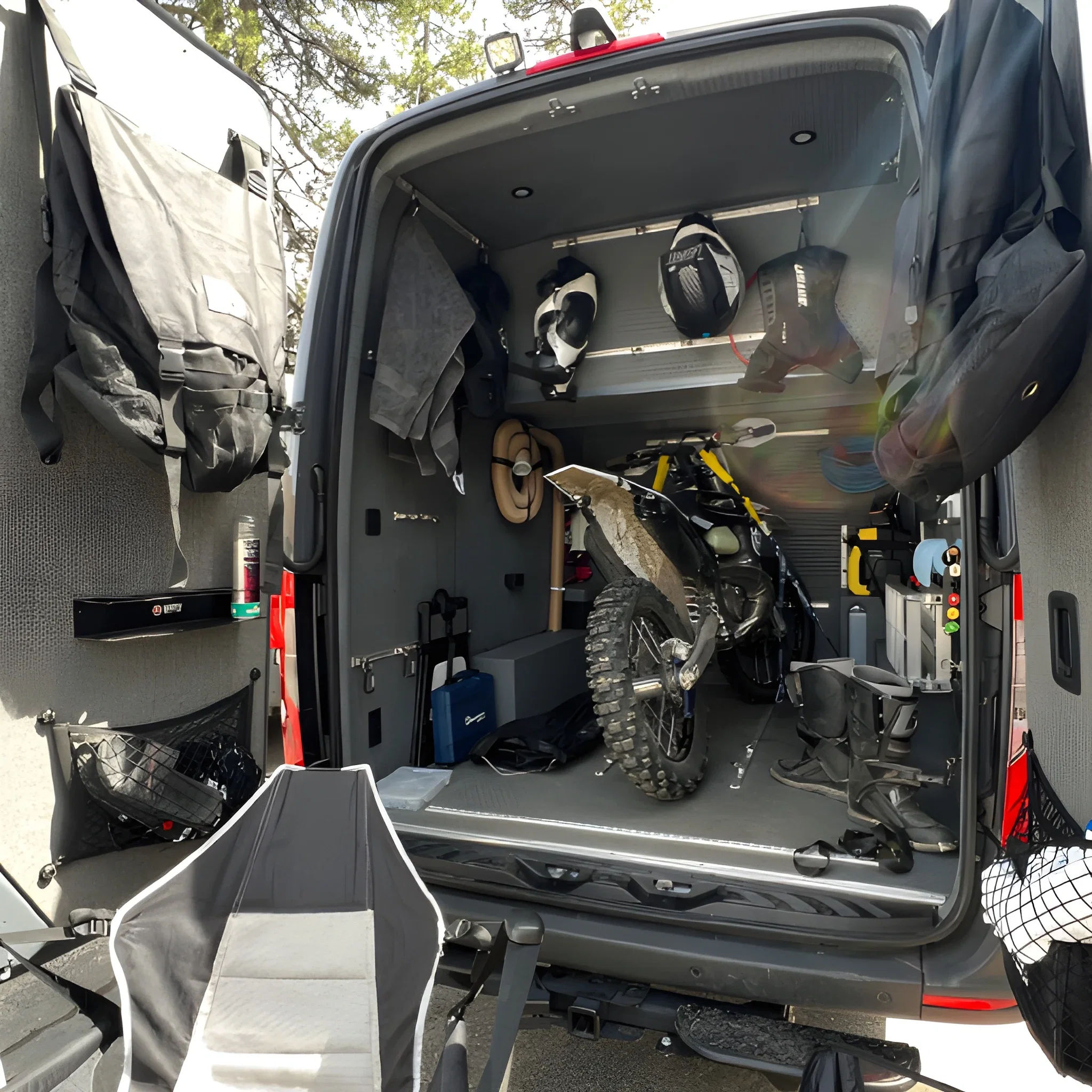 Big Bear Vans Moto Van with rear garage open and three motorcycles loaded